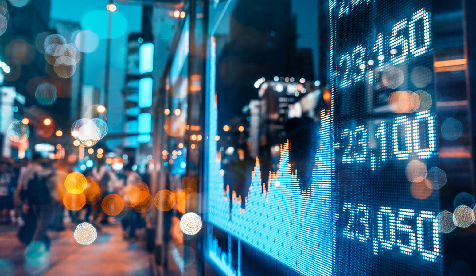 Financial district skyline at night with market data overlay